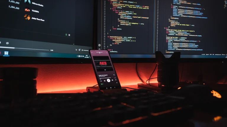 Mobile app development workspace with smartphone and code for Dubai iOS and Android projects